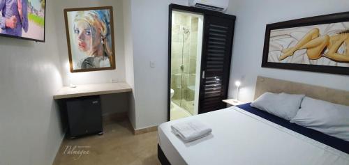 a bedroom with a bed and a glass shower at Palmagua in Barranquilla