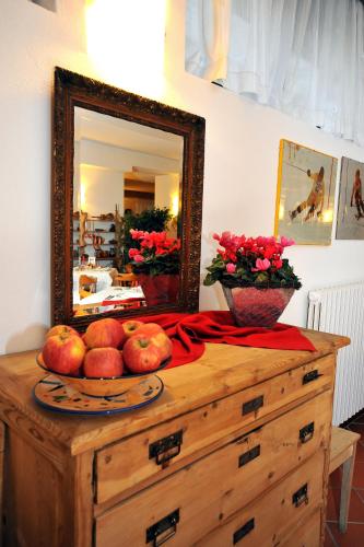 a dresser with a mirror on top of it at Hotel Derby in Bormio