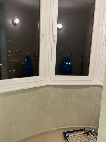 two windows in a room with a view of a city at апартаменти люкс роксолани 16 in Truskavets