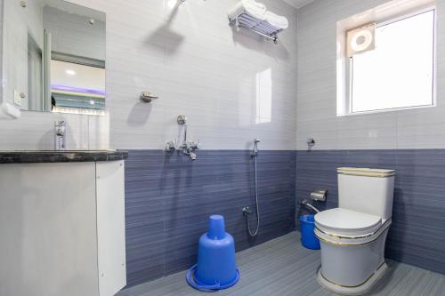 a bathroom with a shower with a toilet and a sink at Siddhartha Hotel Grand City in Birtamode