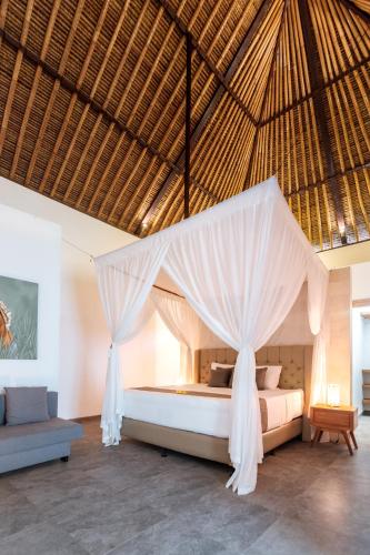 a bedroom with a bed with a mosquito net at Villa Lempuyangdream in Karangasem