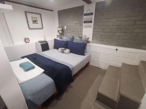 a bedroom with a bed with two stuffed animals on it at The nest in East London
