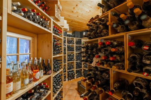 a room filled with lots of bottles of wine at Sport Hotel Alpina in Madesimo