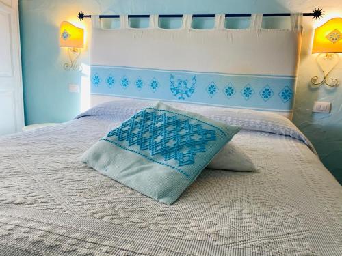 a bedroom with a bed with a pillow on it at Il Nuraghe del lago Coghinas in Oschiri