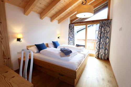 a bedroom with a bed in a room with a window at Pyrit in Saas-Fee