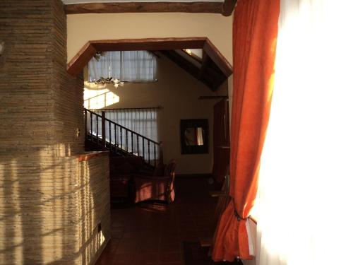 a living room with a staircase and a window at Sangare Gardens- Book Now Enjoy Free Farm Tour in Mweiga