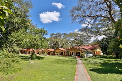 a row of cottages in a park at Muthu Lake Naivasha Country Club, Naivasha in Naivasha