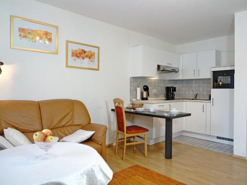 a kitchen and a living room with a couch and a table at Ferien-Oase Bad Dürrheim in Bad Dürrheim