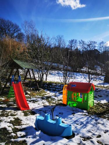 a play set in the snow with a playground at Doftana Apartaments in Teşila