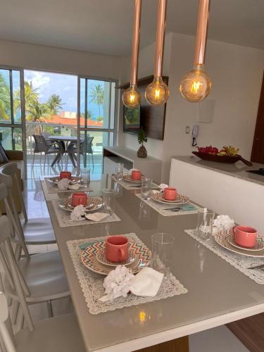 a kitchen with a table with plates of food on it at Solar Porto Rico in Porto De Galinhas