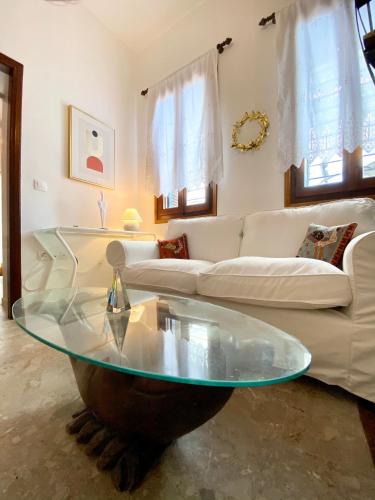 a living room with a couch and a glass table at Lion House I in Ioulida