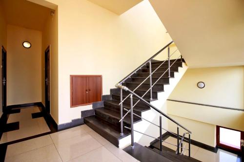 a staircase in a house with black and white floors at Apartments in Alley Residence in Yerevan