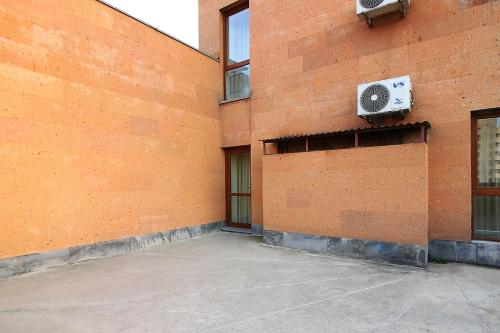 a brick building with a air conditioner on the side of it at Apartments in Alley Residence in Yerevan