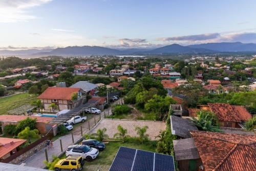 a city with solar panels on the roofs of houses at Pousada Las Piedras in Praia do Rosa