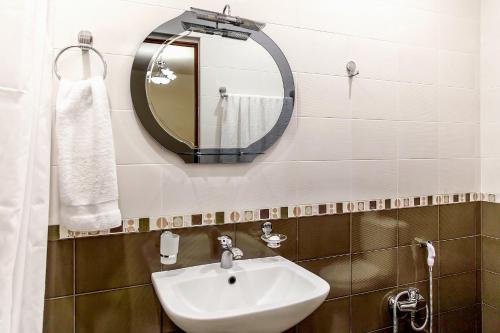 a bathroom with a sink and a mirror at Apartments in Alley Residence in Yerevan