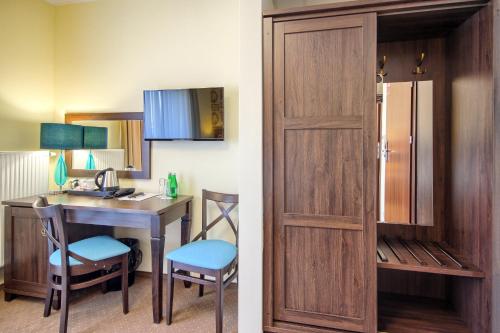 a room with a desk and a room with a door at Hotel Opole Centrum in Opole