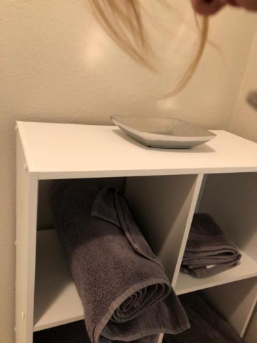 a white shelf with a bowl on top of it at Burrel Avenue Apartments in Cooperstown