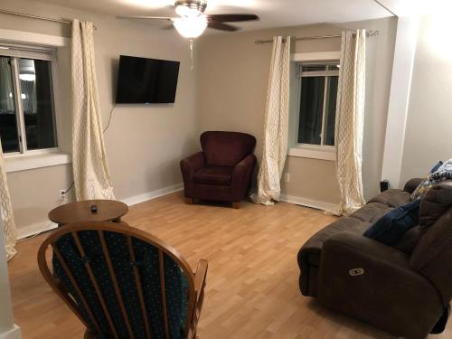 a living room with a couch and a chair at Burrel Avenue Apartments in Cooperstown