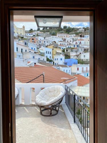a balcony with a bench and a view of a city at Lion House I in Ioulida