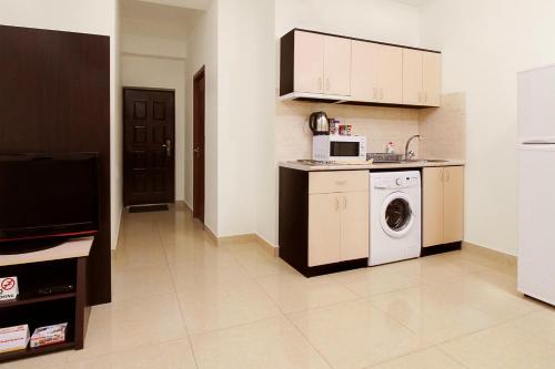 a kitchen with a washing machine and a microwave at Apartments in Alley Residence in Yerevan