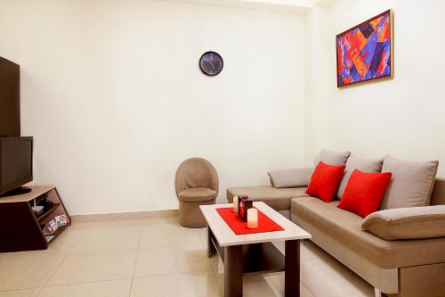 a living room with a couch and a table at Apartments in Alley Residence in Yerevan