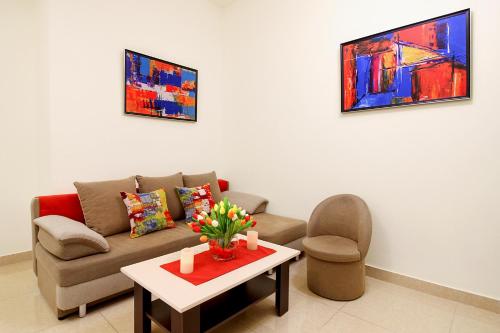 a living room with a couch and a table at Apartments in Alley Residence in Yerevan