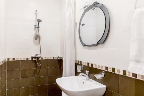 a bathroom with a sink and a mirror at Apartments in Alley Residence in Yerevan