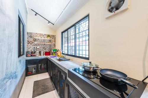 a kitchen with a counter with a frying pan on it at 3BR Family-Friendly Landed House,PandanPerdana,KL by Verano in Kuala Lumpur