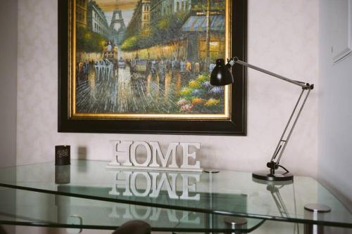 a glass table with a lamp and a painting on the wall at Two BD CN Tower and Lake Ontario View in Toronto