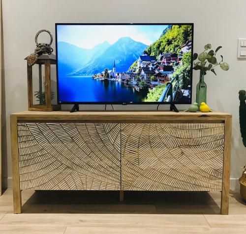 a television on a tv stand in a living room at Cocon douillet face à la mer de Cagnes sur mer in Cagnes-sur-Mer