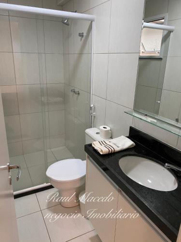 a bathroom with a toilet and a sink and a shower at Beach Way Residence in Aquiraz