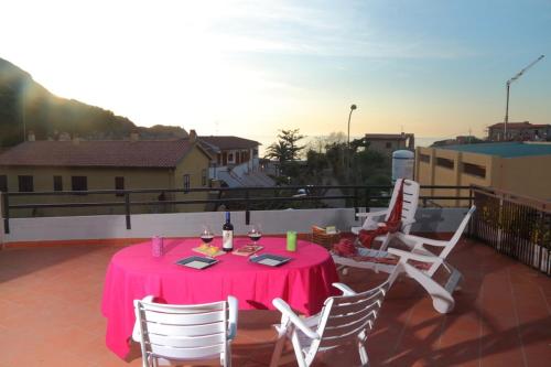 a pink table and chairs on a balcony at Ammiraglio in Campese