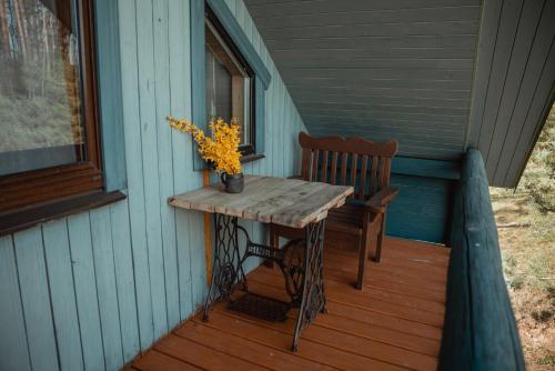 a table and a chair on the porch of a house at Rāznas Stāvkrasti in Kaunata