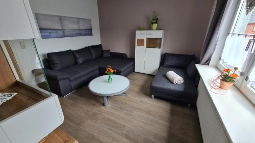a living room with a couch and a table at Marianne in Emden