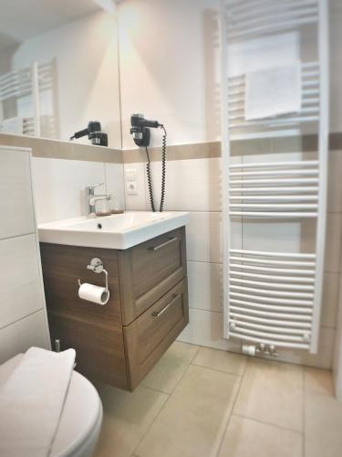 a bathroom with a sink and a toilet at Gasthof Auwirt in Sankt Michael im Lungau