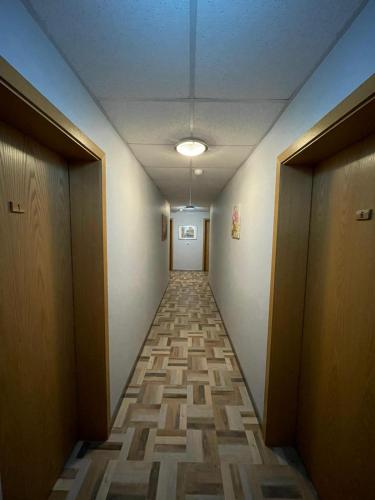 a hallway with a long corridor with doors and a hallwayngthngthngthngthngth at Landgasthaus Zander in Blankenburg