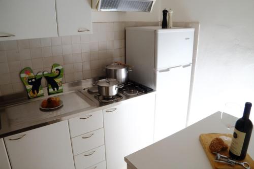 a kitchen with a white refrigerator and a counter top at Ammiraglio in Campese