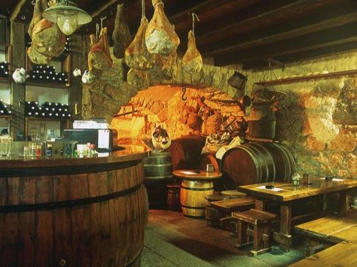 a bar with a large stone fireplace in a room at Apartments Adriatic 3 in Selce
