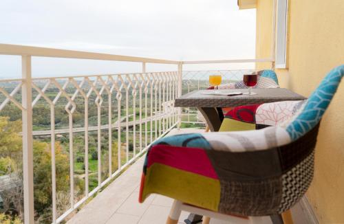 a balcony with a table and chairs with a view at South Valley in Agrigento