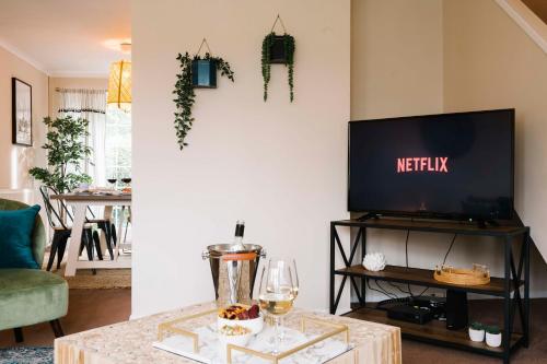 a living room with a tv and a table at Castle Gate by Spa Town Property - Central Location with Large Living Space in Warwick