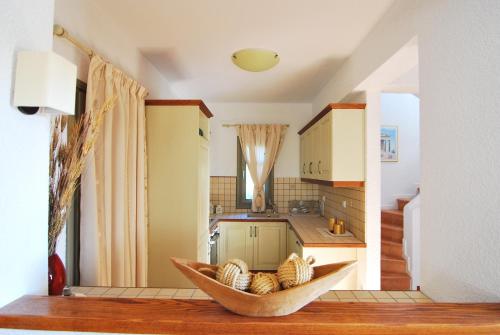 a kitchen with a bowl of food on a table at Elaia Villas in Pythagoreio