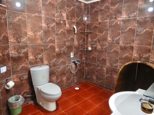 a bathroom with a toilet and a shower and a sink at TREE HOUSE in Pingtung County