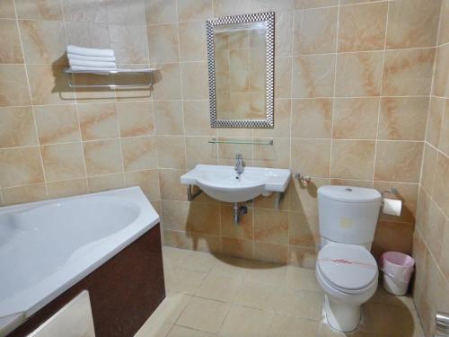 a bathroom with a toilet and a sink and a tub at TREE HOUSE in Pingtung County