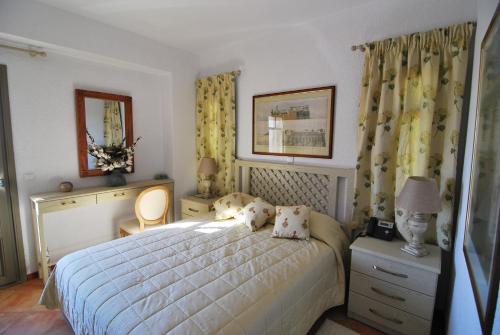 a bedroom with a bed with two pillows on it at Elaia Villas in Pythagoreio
