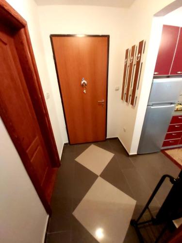 a hallway with a brown door and a tile floor at Amore@Tivat in Tivat