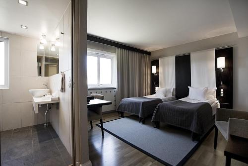 Säng eller sängar i ett rum på Hotel Tylösand