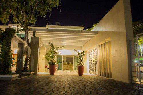 a building with potted plants on the side of it at Real del Sol in Rincon de Guayabitos