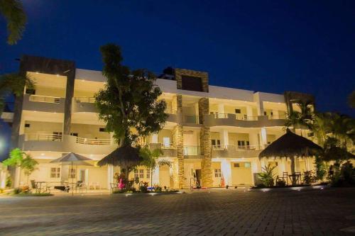 a large building with umbrellas in front of it at Real del Sol in Rincon de Guayabitos