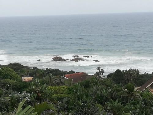 a view of the ocean with rocks in the water at Surf and Sand - Breakerview in Margate