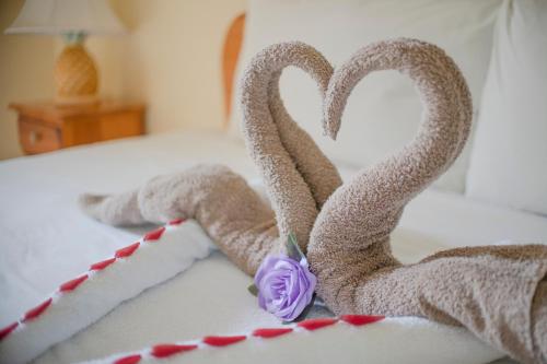 a cake shaped like two swans on a bed at Bay View Eco Resort & Spa in Port Antonio